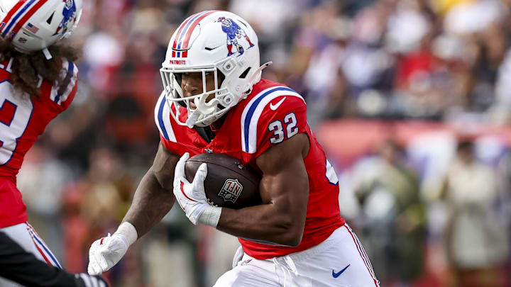 Sep 21, 2025; Foxborough, Massachusetts, USA; New England Patriots running back Treveyon Henderson (32) runs the ball during the third quarter at Gillette Stadium. Mandatory Credit: Paul Rutherford-Imagn Images