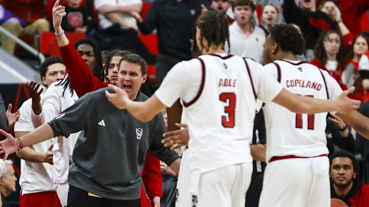 Jan 27, 2026; Raleigh, North Carolina, USA; NC State Wolfpack head coach Will Wade and bench react to the call during the second half of the game against the Syracuse Orange at Lenovo Center. Mandatory Credit: Jaylynn Nash-Imagn Images