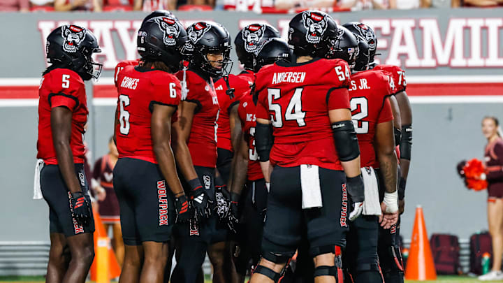 Sep 27, 2025; Raleigh, North Carolina, USA;  North Carolina State Wolfpack huddle during the first half of the game against Virginia Tech Hokies at Carter-Finley Stadium. Mandatory Credit: Jaylynn Nash-Imagn Images