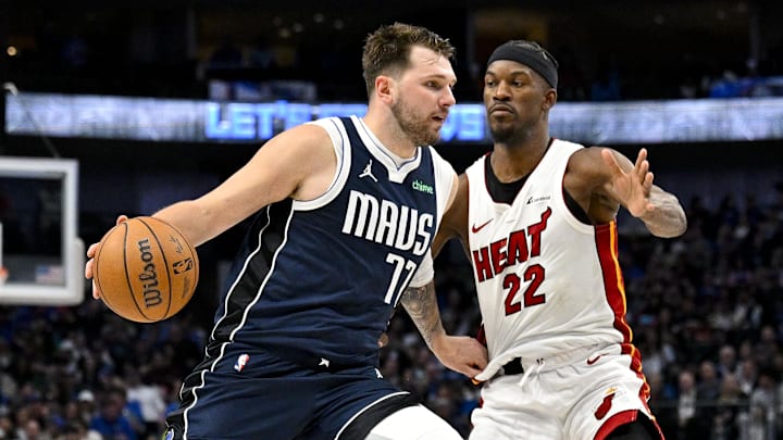 Mar 7, 2024; Dallas, Texas, USA; Dallas Mavericks guard Luka Doncic (77) looks the ball past Miami Heat forward Jimmy Butler (22) during the second half at the American Airlines Center. Mandatory Credit: Jerome Miron-Imagn Images