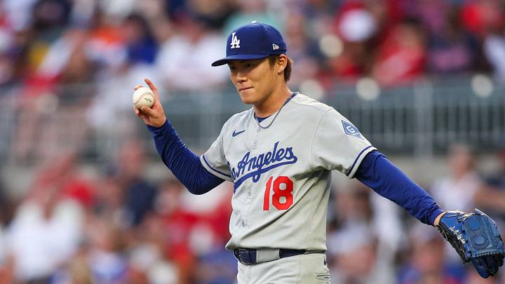 May 2, 2025; Atlanta, Georgia, USA; Los Angeles Dodgers starting pitcher Yoshinobu Yamamoto (18) reacts after catching a line drive against the Atlanta Braves in the second inning at Truist Park. Mandatory Credit: Brett Davis-Imagn Images
