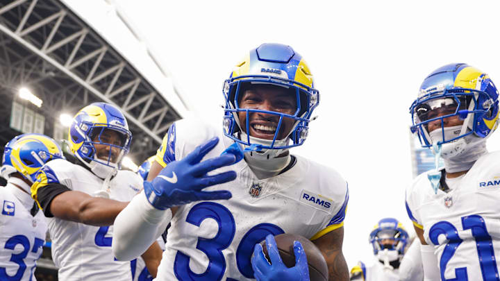 Nov 3, 2024; Seattle, Washington, USA; Los Angeles Rams safety Jaylen McCollough (39) celebrates with teammates, including cornerback Ahkello Witherspoon (4) and cornerback Charles Woods (21) following a first quarter interception against the Seattle Seahawks at Lumen Field. Mandatory Credit: Joe Nicholson-Imagn Images