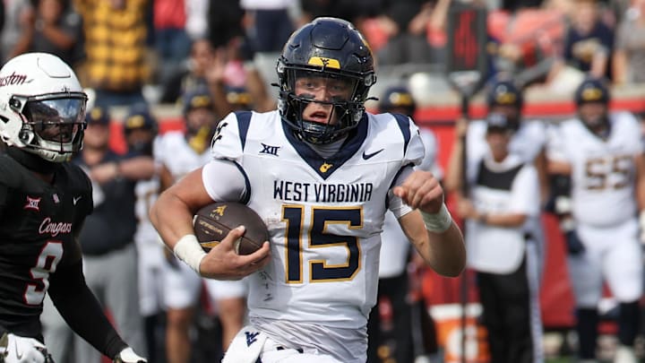 Nov 1, 2025; Houston, Texas, USA; West Virginia Mountaineers quarterback Scotty Fox Jr. (15) rushes for a touchdown against tHouston Cougars linebacker Corey Platt Jr. (9)  in the second half at TDECU Stadium. Mandatory Credit: Thomas Shea-Imagn Images