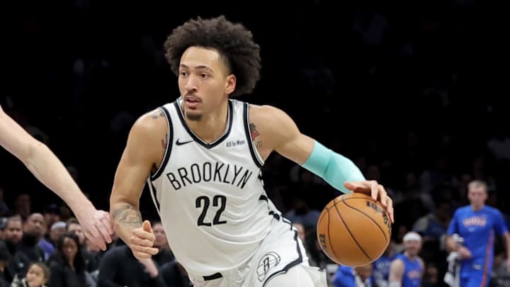 Mar 18, 2026; Brooklyn, New York, USA; Brooklyn Nets forward Jalen Wilson (22) drives to the basket against Oklahoma City Thunder forward Brooks Barnhizer (23) and guard Kenrich Williams (34) during the fourth quarter at Barclays Center. Mandatory Credit: Brad Penner-Imagn Images