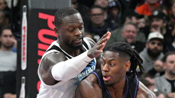 Toronto Raptors forward Jonathan Mogbo holds the ball away from Minnesota Timberwolves forward Julius Randle.