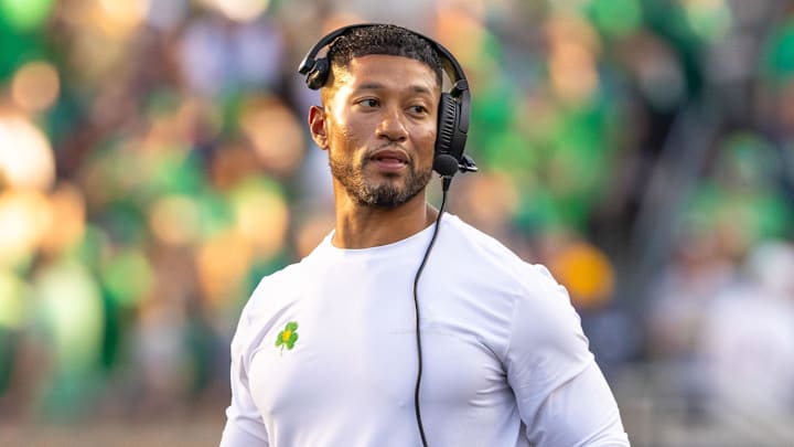 Oct 4, 2025; South Bend, Indiana, USA; Notre Dame head football coach Marcus Freeman adjusts his radio against the Boise State Broncos at Notre Dame Stadium. 