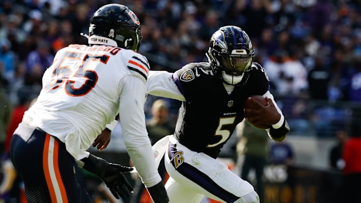 Oct 26, 2025; Baltimore, Maryland, USA; Baltimore Ravens quarterback Tyler Huntley (5) runs with the ball as Chicago Bears defensive end Dayo Odeyingbo (55) chases in the third quarter at M&T Bank Stadium.