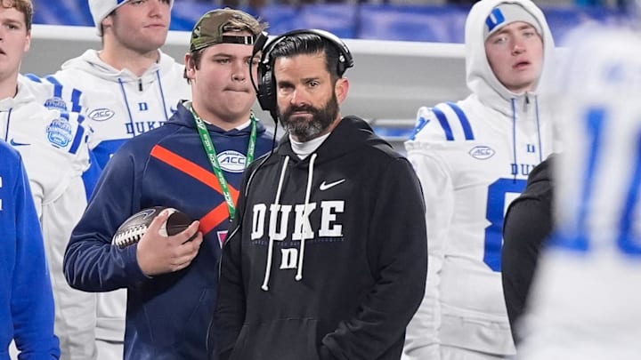 Dec 6, 2025; Charlotte, NC, USA; Duke Blue Devils head coach Manny Diaz looks on during the second half against the Virginia Cavaliers during the 2025 ACC Championship game at Bank of America Stadium. Mandatory Credit: Jim Dedmon-Imagn Images Dec 6, 2025; Charlotte, NC, USA; Duke Blue Devils head coach Manny Diaz looks on during the second half against the Virginia Cavaliers during the 2025 ACC Championship game at Bank of America Stadium. Mandatory Credit: Jim Dedmon-Imagn Images