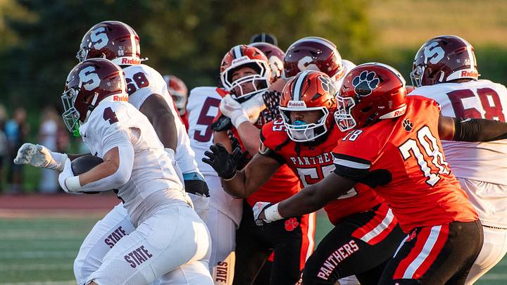 State College's Rowan Walker (4) finds the hole created by his offensive line to gain yardage on Central York on Friday, Aug. 28, 2026. State College's Rowan Walker (4) finds the hole created by his offensive line to gain yardage on Central York on Friday, Aug. 28, 2026.