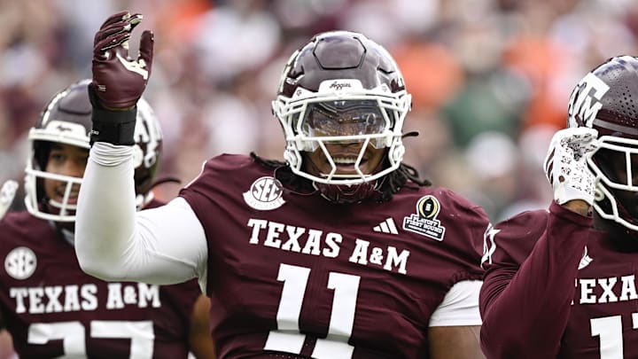 Dec 20, 2025; College Station, TX, USA; Texas A&M Aggies defensive tackle Tyler Onyedim (11) celebrates a sack with defensive tackle Albert Regis (17) during first half of the first round game of the CFP National Playoff against the Miami Hurricanes at Kyle Field. Mandatory Credit: Jerome Miron-Imagn Images
