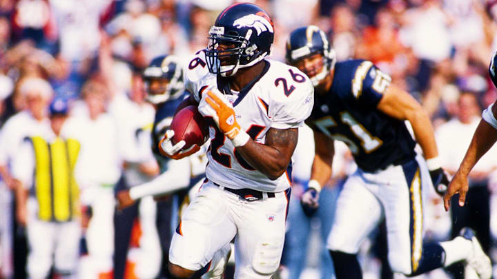 Dec 1, 2002; San Diego, CA, USA; FILE PHOTO; Denver Broncos running back Clinton Portis (26) in action against San Diego Chargers defenders Rodney Harrison (37) and Ben Leber (51) at Qualcomm Stadium. 