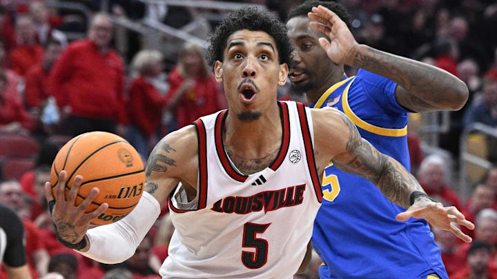 Mar 1, 2025; Louisville, Kentucky, USA;  Louisville Cardinals guard Terrence Edwards Jr. (5) drives to the basket against Pittsburgh Panthers forward Guillermo Diaz Graham (25) during the second half at KFC Yum! Center. Louisville defeated Pittsburgh 79-68. Mandatory Credit: Jamie Rhodes-Imagn Images