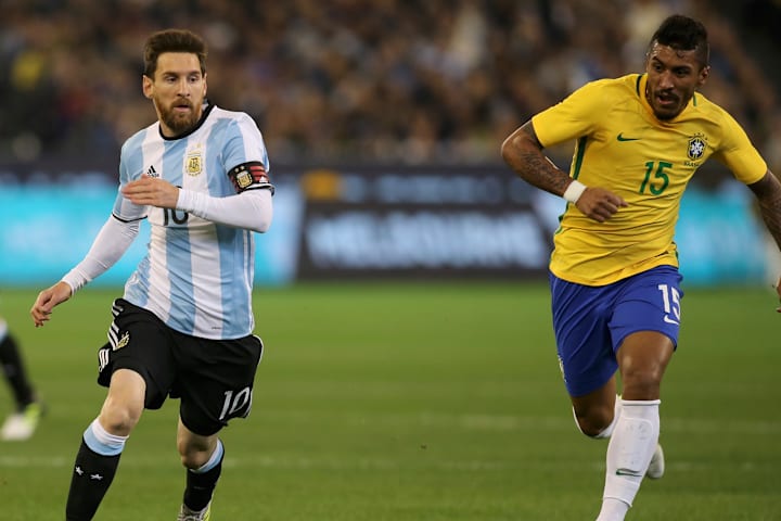 Lionel Messi and Paulinho