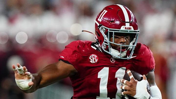 Alabama Crimson Tide linebacker Jihaad Campbell returns an interception against Georgia Bulldogs wide receiver Dillon Bell.