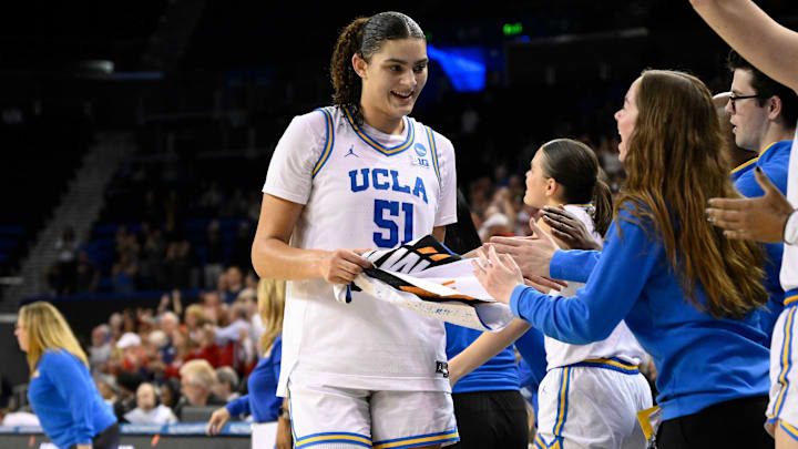 Mar 23, 2025; Los Angeles, California, USA; UCLA Bruins center Lauren Betts (51) and UCLA Bruins guard Kiki Rice (background) go to the bench in the closing minutes of the Bruins win over Richmond Spiders during an NCAA Tournament second round game at Pauley Pavilion presented by Wescom. Mandatory Credit: Robert Hanashiro-Imagn Images