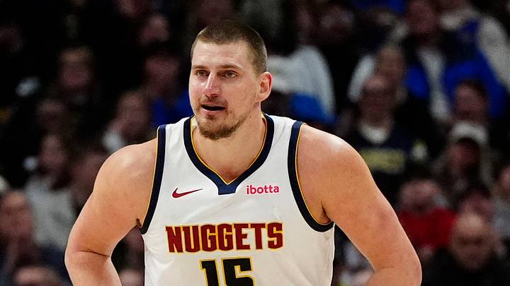 Jan 1, 2025; Denver, Colorado, USA; Denver Nuggets center Nikola Jokic (15) reacts back to the bench after scoring on his own rebounded ball in the second half against the Atlanta Hawks at Ball Arena. Mandatory Credit: Ron Chenoy-Imagn Images