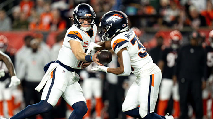 Denver Broncos quarterback Bo Nix (10) hands the ball off to Denver Broncos running back Jaleel McLaughlin (38) in the third quarter of the NFL game against the Cincinnati Bengals at Paycor Stadium in Cincinnati on Saturday, Dec. 28, 2024.
