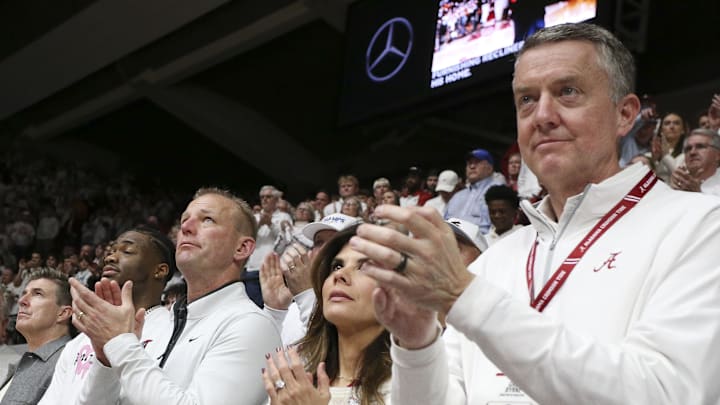 Mar 2, 2024; Tuscaloosa, Alabama, USA;  Alabama head football coach Kalen DeBoer stands beside quarterback Jalen Milroe to his left and Alabama Athletics Director Greg Byrne at right at Coleman Coliseum. Mandatory Credit: Gary Cosby Jr.-Imagn Images