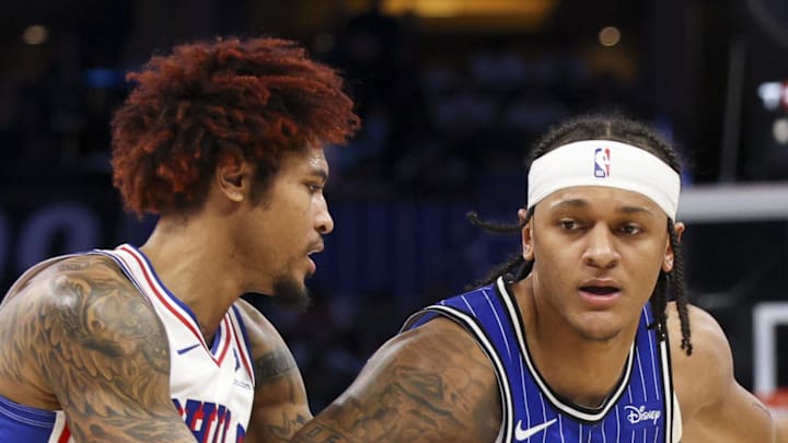 Orlando Magic forward Paolo Banchero is guarded by Philadelphia 76ers guard Kelly Oubre Jr.