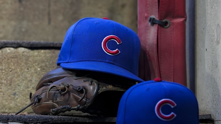 Chicago Cubs player hats on dugout steps