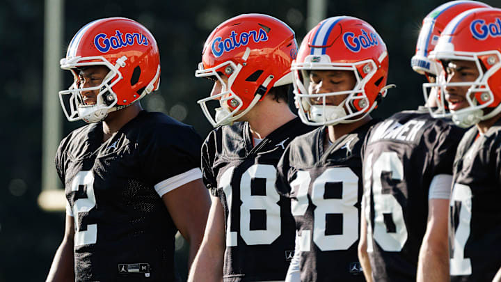 Florida Gators quarterback DJ Lagway (2), Florida Gators quarterback Clay Millen (18) and Florida Gators quarterback Aaron Williams (28) watch a drill during spring football practice at Heavener Football Complex at the University of Florida in Gainesville, FL on Thursday, March 6, 2025. [Matt Pendleton/Gainesville Sun]
