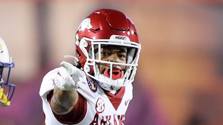 Dec 28, 2022; Memphis, TN, USA; Arkansas Razorbacks wide receiver Jaedon Wilson (13) signals first down after catching a pass against Kansas Jayhawks linebacker Rich Miller (30) in the first quarter in the 2022 Liberty Bowl at Liberty Bowl Memorial Stadium. Mandatory Credit: Nelson Chenault-Imagn Images