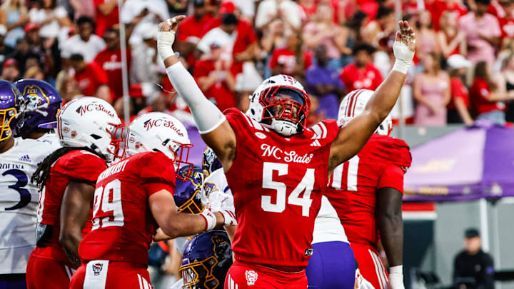 Aug 28, 2025; Raleigh, North Carolina, USA; North Carolina State Wolfpack defensive end Sabastian Harsh (54) celebrates a sack during the first half of the game against East Carolina Pirates at Carter-Finley Stadium. Mandatory Credit: Jaylynn Nash-Imagn Images
