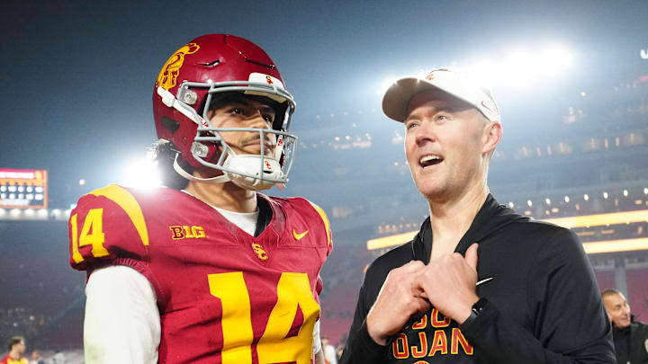 Nov 29, 2025; Los Angeles, California, USA; Southern California Trojans quarterback Jayden Maiava (14) and head coach Lincoln Riley react after the game against the UCLA Bruins at United Airlines Field at Los Angeles Memorial Coliseum. Mandatory Credit: Kirby Lee-Imagn Images