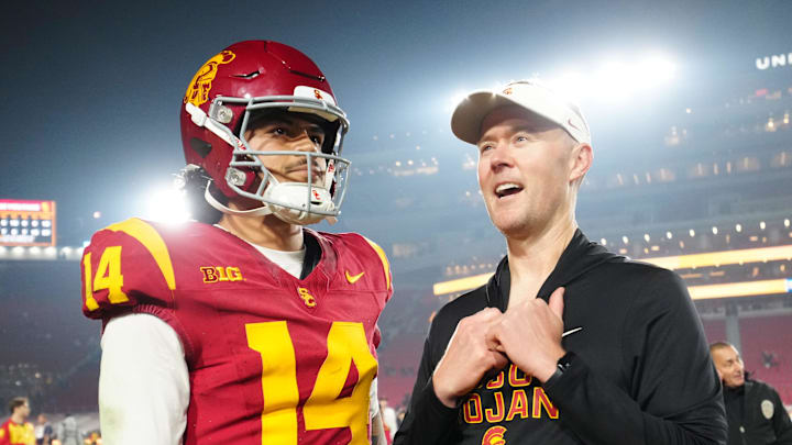 Nov 29, 2025; Los Angeles, California, USA; Southern California Trojans quarterback Jayden Maiava (14) and head coach Lincoln Riley react after the game against the UCLA Bruins at United Airlines Field at Los Angeles Memorial Coliseum. Mandatory Credit: Kirby Lee-Imagn Images