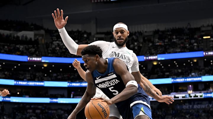 Jan 22, 2025; Dallas, Texas, USA; Minnesota Timberwolves guard Anthony Edwards (5) drives to the basket past Dallas Mavericks center Daniel Gafford (21) during the first half at the American Airlines Center. Mandatory Credit: Jerome Miron-Imagn Images