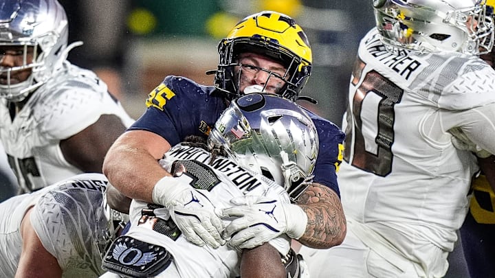 Michigan defensive lineman Mason Graham (55) tackles Oregon running back Noah Whittington (6) during the second half at Michigan Stadium in Ann Arbor on Saturday, Nov. 2, 2024.