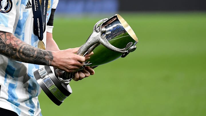Lionel Messi of Argentina celebrates with the trophy at the...