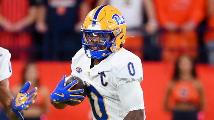 Oct 18, 2025; Syracuse, New York, USA; Pittsburgh Panthers running back Desmond Reid (0) runs with the ball as Syracuse Orange defensive back Demetres Samuel Jr. (1) defends during the first half at the JMA Wireless Dome. Mandatory Credit: Rich Barnes-Imagn Images