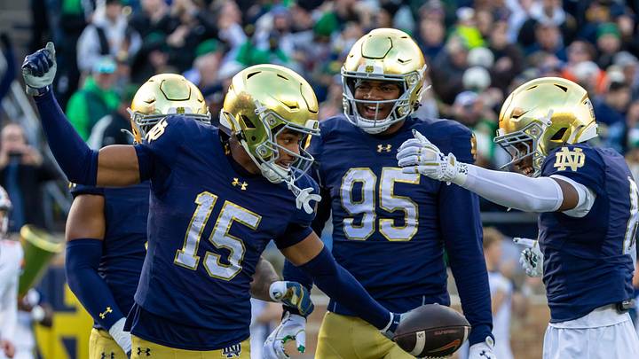 Nov 22, 2025; South Bend, Indiana, USA; Notre Dame Fighting Irish cornerback Leonard Moore (15) celebrates with defensive lineman Bryce Young (95) and cornerback Christian Gray (6) after scoring against the Syracuse Orange during the first half at Notre Dame Stadium. Mandatory Credit: Michael Caterina-Imagn Images