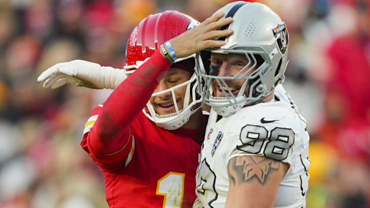 Nov 29, 2024; Kansas City, Missouri, USA; Kansas City Chiefs quarterback Patrick Mahomes (15) and Las Vegas Raiders defensive end Maxx Crosby (98) embrace during the second half at GEHA Field at Arrowhead Stadium. Mandatory Credit: Jay Biggerstaff-Imagn Images
