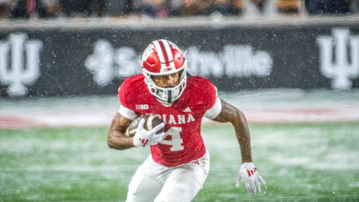 Indiana's Myles Price (4) runs a reverse during the Indiana versus Purdue football game at Memorial Stadium on Saturday, Nov. 30, 2024.