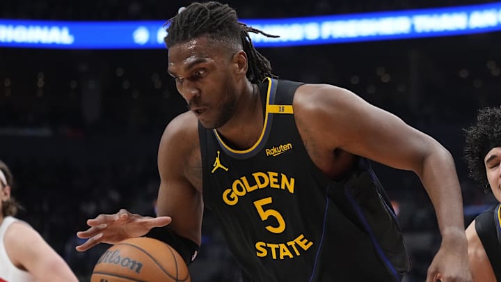 Jan 13, 2025; Toronto, Ontario, CAN; Golden State Warriors forward Kevon Looney (5) collects a rebound against the Toronto Raptors as Golden State Warriors forward Gui Santos (15) reacts during the first half at Scotiabank Arena. Mandatory Credit: John E. Sokolowski-Imagn Images