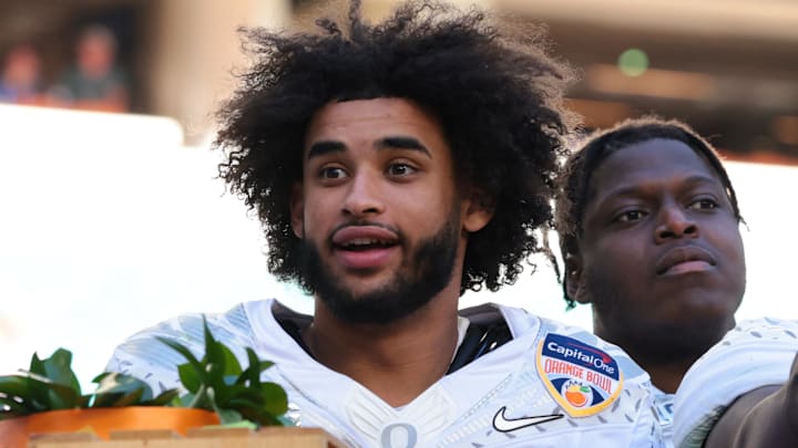 Jan 1, 2026; Miami Gardens, FL, USA; Oregon Ducks quarterback Dante Moore (5), wide receiver Malik Benson (4), defensive back Brandon Finney (4) and defensive lineman Bear Alexander (1) celebrate following the 2025 Orange Bowl and quarterfinal game of the College Football Playoff against the Texas Tech Red Raiders at Hard Rock Stadium. Mandatory Credit: Sam Navarro-Imagn Images
