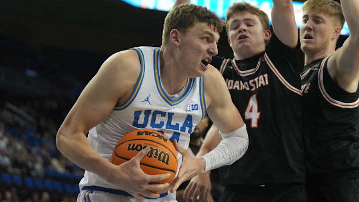 Nov 20, 2024; Los Angeles, California, USA; UCLA Bruins forward Tyler Bilodeau (34) is defended by Idaho State Bengals guard Jaedyn Brown (4) in the second half at Pauley Pavilion presented by Wescom. Mandatory Credit: Kirby Lee-Imagn Images