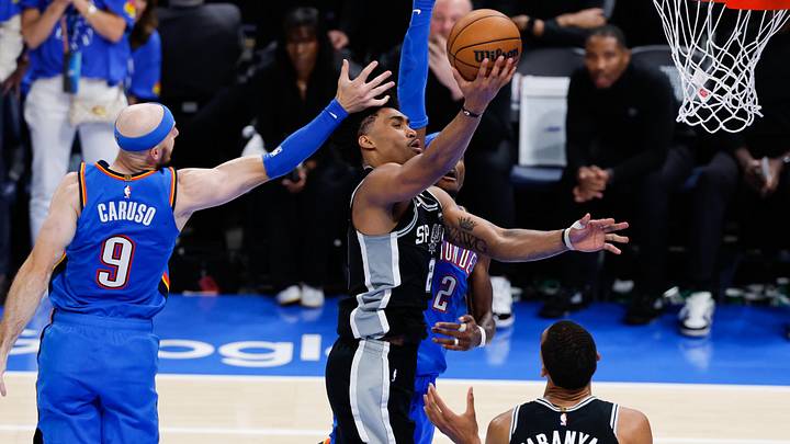 May 18, 2026; Oklahoma City, Oklahoma, USA; San Antonio Spurs guard Dylan Harper (2) shoots while defined by Oklahoma City Thunder guard Alex Caruso (9) in overtime during game one of the western conference finals for the 2026 NBA playoffs at Paycom Center. Mandatory Credit: Alonzo Adams-Imagn Images