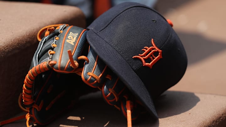 Detroit Tigers hat and glove is shown in their dugout Detroit Tigers hat and glove is shown in their dugout