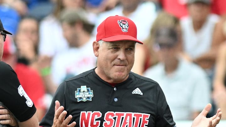 Jun 15, 2024; Omaha, NE, USA;  NC State Wolfpack head coach Elliott Avent discusses a balk call with an umpire in the game against the Kentucky Wildcats during the eighth inning at Charles Schwab Field Omaha. Mandatory Credit: Steven Branscombe-Imagn Images
