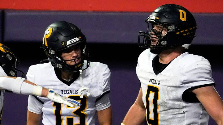 Iowa City Regina’s Tate Wallace (0) celebrates with teammates after scoring a touchdown Nov. 20, 2025 during the Class 1A state football championship against the West Lyon Wildcats at the UNI-Dome in Cedar Falls, Iowa.