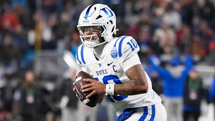 Dec 6, 2025; Charlotte, NC, USA; Duke Blue Devils quarterback Darian Mensah (10) looks to pass during over time against the Virginia Cavaliers during the 2025 ACC Championship game at Bank of America Stadium. Mandatory Credit: Jim Dedmon-Imagn Images