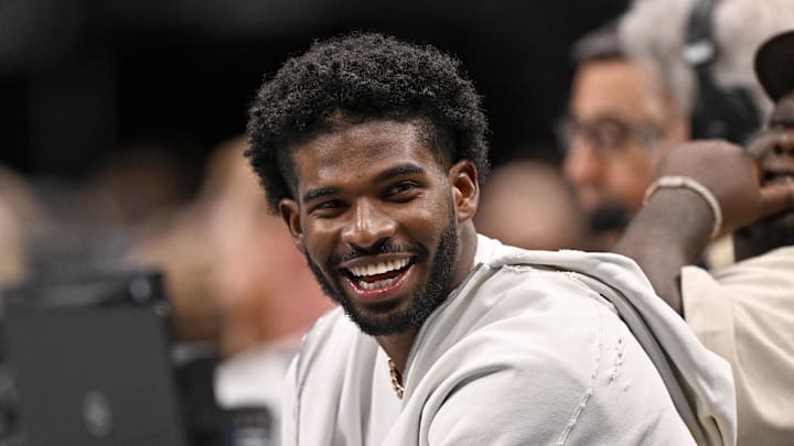 Jan 14, 2025; Dallas, Texas, USA; Colorado Buffaloes quarterback Shedeur Sanders laughs as he watches the game between the Dallas Mavericks and the Denver Nuggets during the second half at the American Airlines Center. Mandatory Credit: Jerome Miron-Imagn Images Jan 14, 2025; Dallas, Texas, USA; Colorado Buffaloes quarterback Shedeur Sanders laughs as he watches the game between the Dallas Mavericks and the Denver Nuggets during the second half at the American Airlines Center. Mandatory Credit: Jerome Miron-Imagn Images