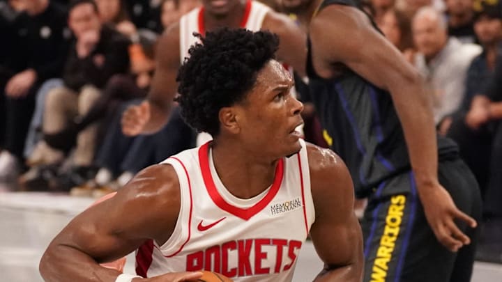 Nov 26, 2025; San Francisco, California, USA;  Houston Rockets guard-forward Amen Thompson (1) drives to the basket while defended by Golden State Warriors guard Stephen Curry (30) in the fourth quarter at Chase Center. Mandatory Credit: David Gonzales-Imagn Images