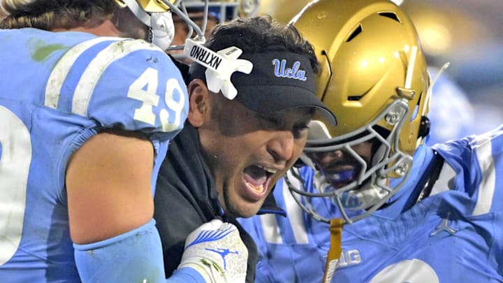 Nov 8, 2024; Pasadena, California, USA; UCLA Bruins defensive coordinator Ikaika Malloe, center, celebrates with linebacker Carson Schwesinger (49) defensive back Jaylin Davies (6) after an interception in the second half against the Iowa Hawkeyes at the Rose Bowl. Mandatory Credit: Jayne Kamin-Oncea-Imagn Images Nov 8, 2024; Pasadena, California, USA; UCLA Bruins defensive coordinator Ikaika Malloe, center, celebrates with linebacker Carson Schwesinger (49) defensive back Jaylin Davies (6) after an interception in the second half against the Iowa Hawkeyes at the Rose Bowl. Mandatory Credit: Jayne Kamin-Oncea-Imagn Images