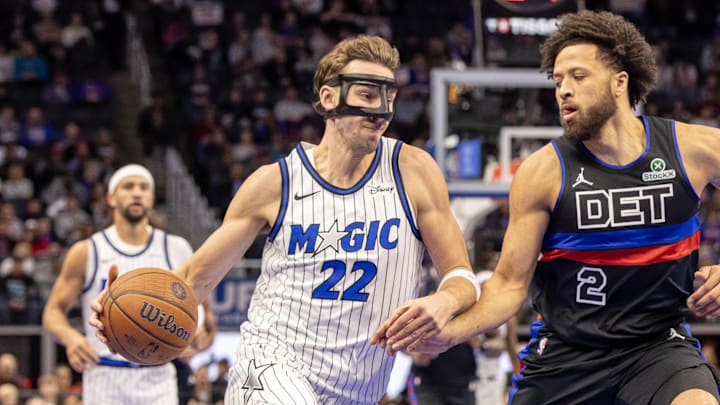 Nov 28, 2025; Detroit, Michigan, USA; Orlando Magic forward Franz Wagner (22) drives to the basket as Detroit Pistons guard Cade Cunningham (2) defends during the first quarter at Little Caesars Arena. Mandatory Credit: David Reginek-Imagn Images