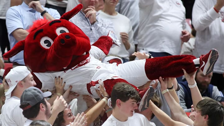 The Razorbacks mascot crowd surfs in the student section during the second half of Arkansas' 80-75 win over Duke in the SEC-ACC Challenge on November 29, 2023.