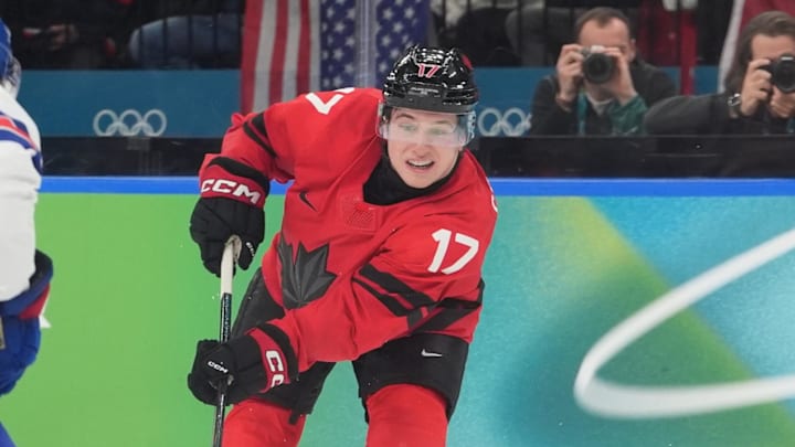 Feb 22, 2026; Milan, Italy; Macklin Celebrini (17) of Canada in action against Quinn Hughes (43) of the United States in the men's ice hockey gold medal game during the Milano Cortina 2026 Olympic Winter Games at Milano Santagiulia Ice Hockey Arena. Mandatory Credit: Amber Searls-Imagn Images